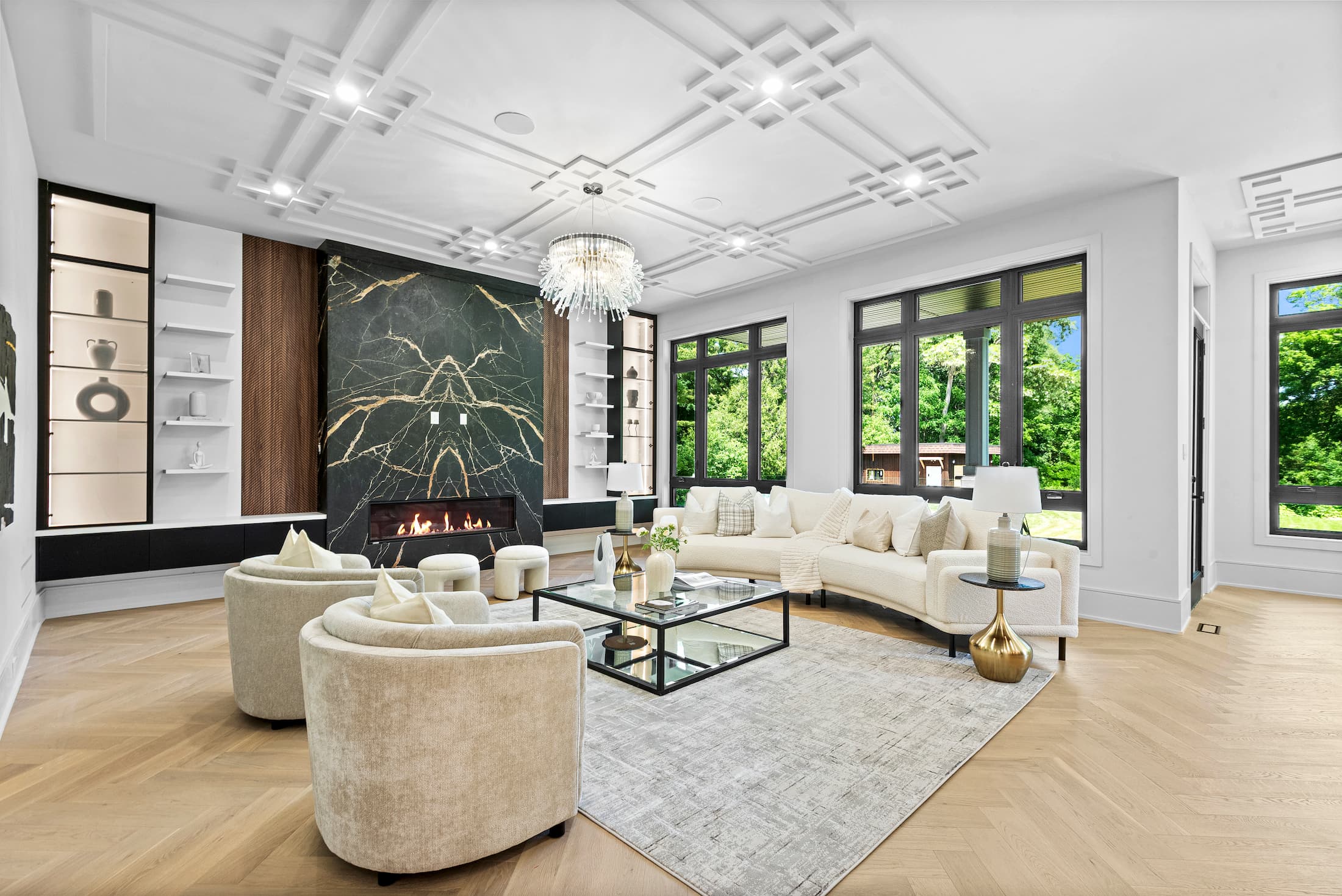 Bright and spacious modern living room in a Whitby custom home, featuring a marble fireplace and coffered ceiling detail.