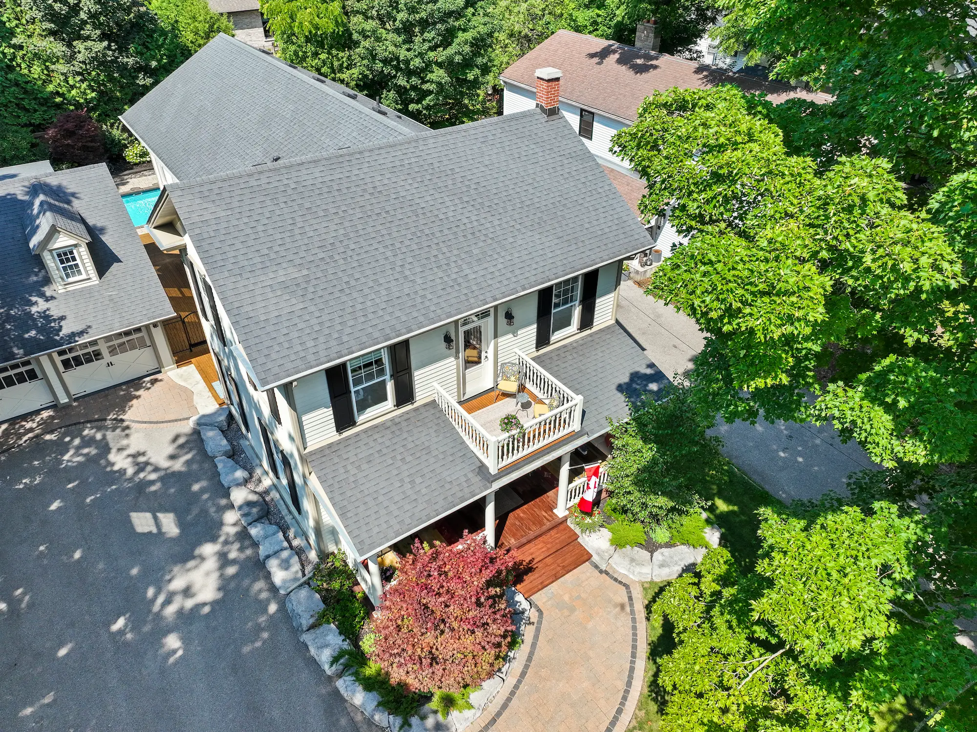 High-end drone shot of a detached home in Port Perry, capturing the architecture and landscaping for a real estate listing.