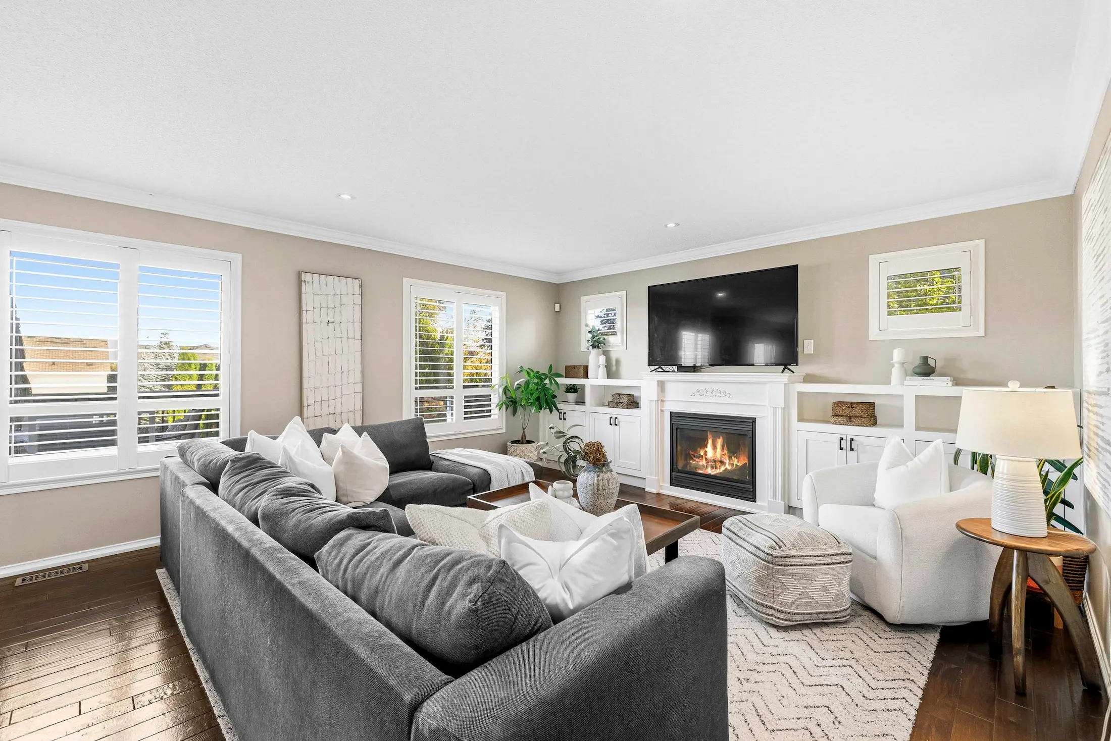 Professional real estate photography Oshawa showcasing the cozy fireplace and modern seating area of this beautiful Oshawa property